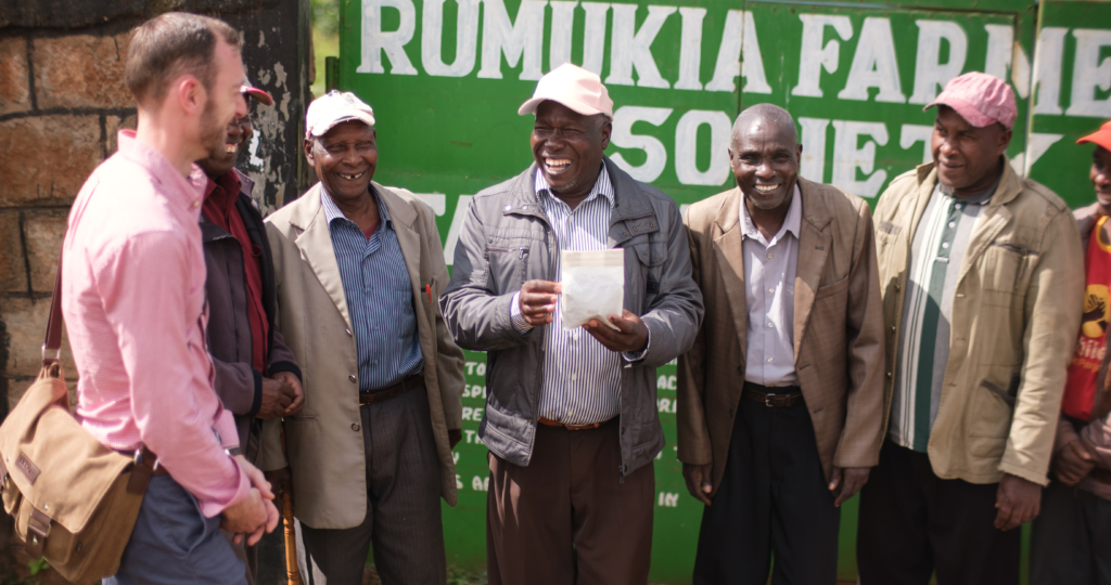 man with Kenyan men smiling