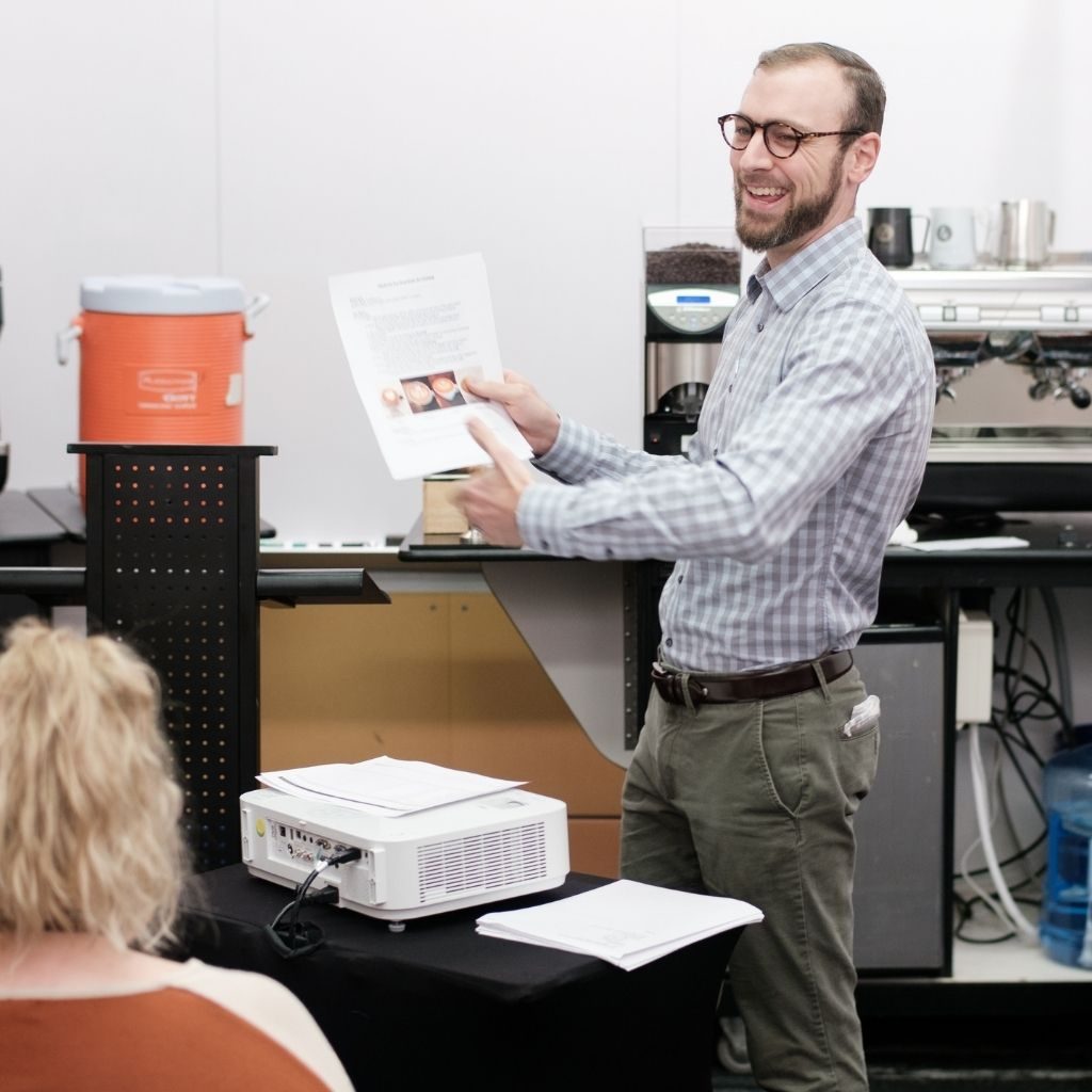 man pointing at paper and teaching