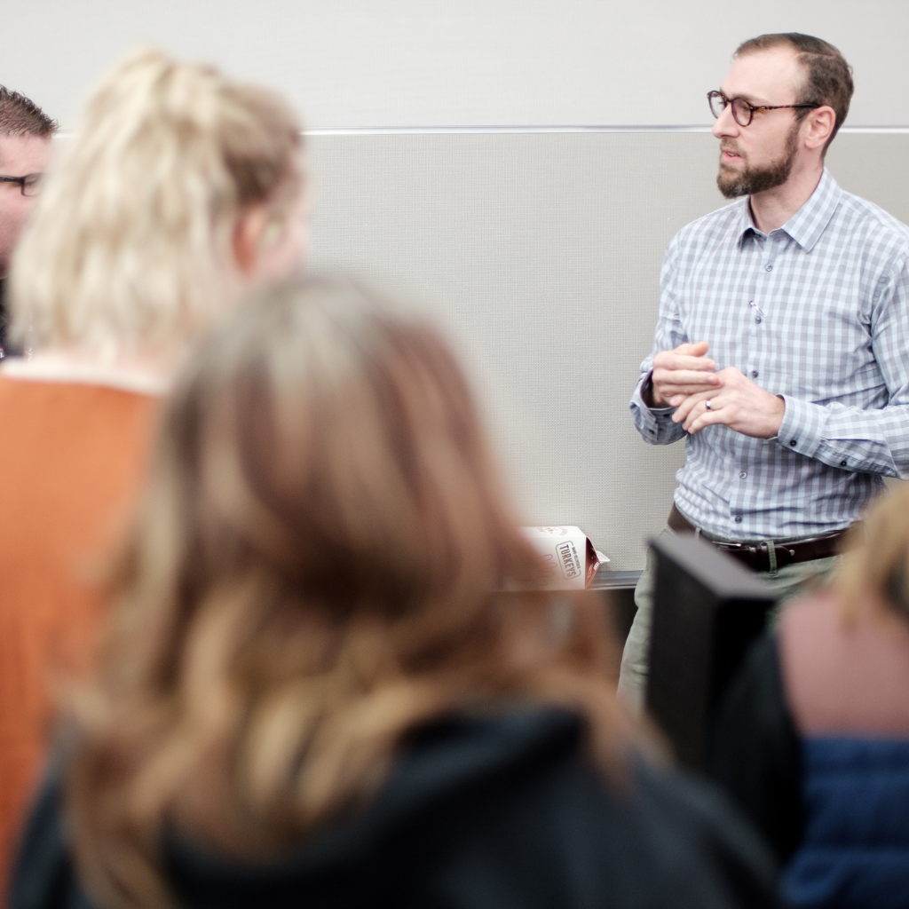 man talking to students